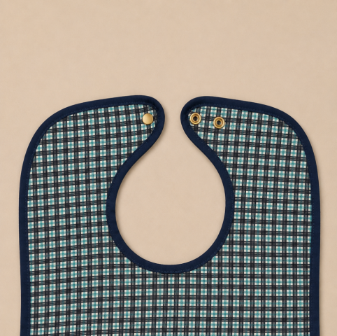 BABERO ECO CUADROS BROCHES 50X80